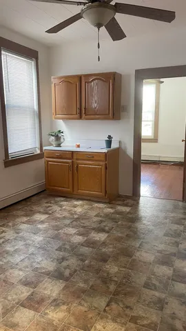 a large kitchen with stainless steel appliances granite countertop a stove and cabinets