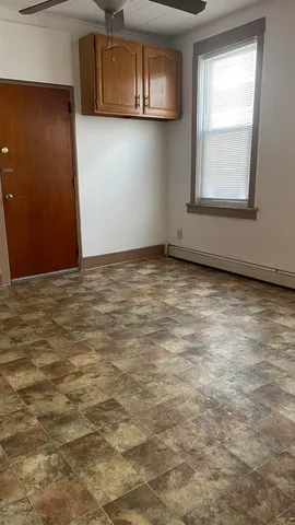 a view of a livingroom with an empty space and a window