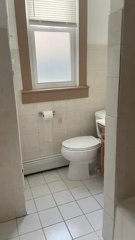 a bathroom with a toilet a sink and a mirror