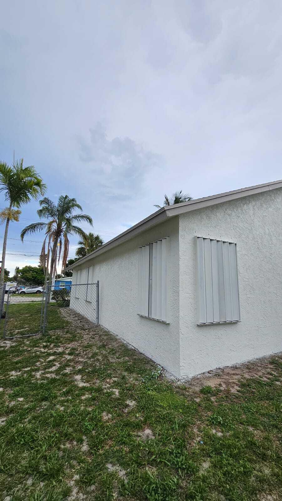 3391 Avenue South Riviera Beach, FL 33404 - Photo 3 of 16 a backyard of a house with lots of green space and garden