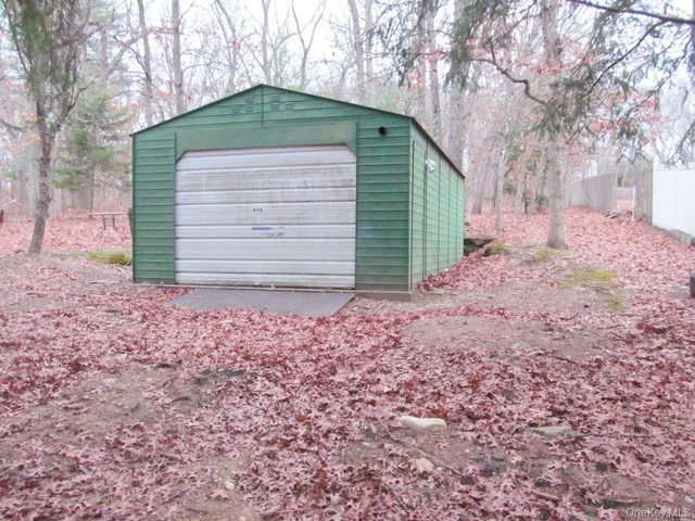 a view of a house with a tree in front of it