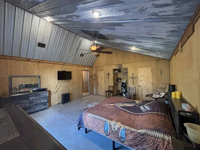 a bed room with a bed and a television