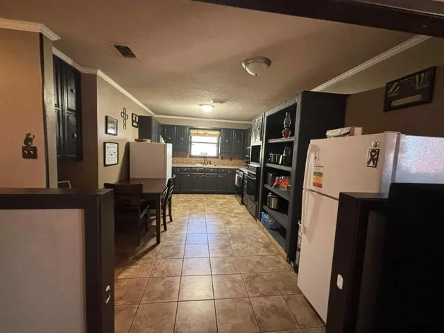 a refrigerator freezer sitting inside of a kitchen