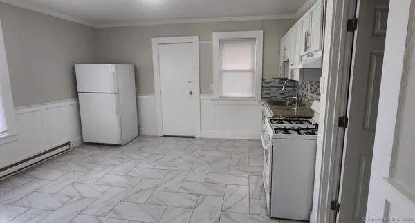 a view of a kitchen with a refrigerator