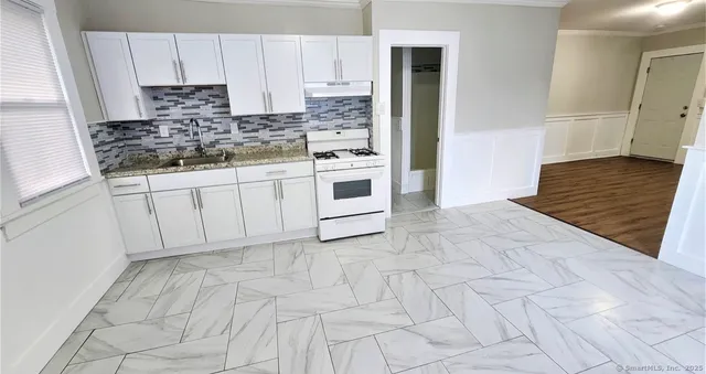 a kitchen with stainless steel appliances cabinets a sink and a stove