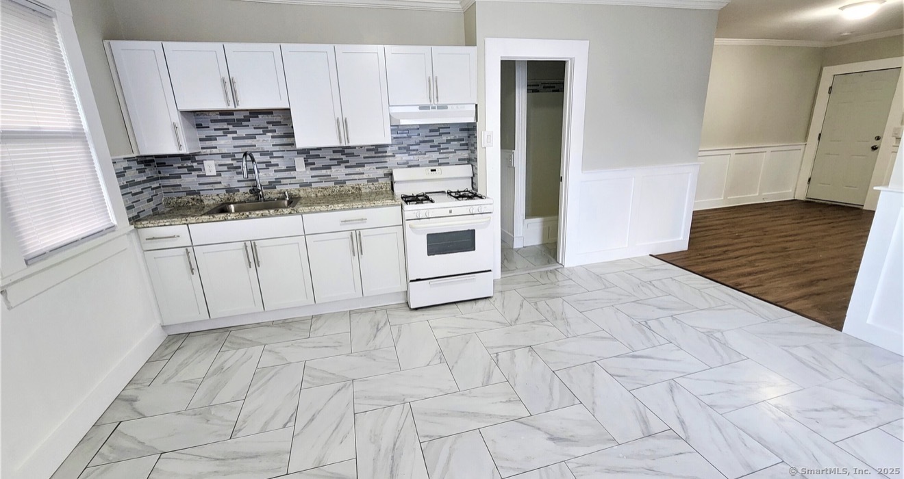 1514 Pembroke Street, Unit 2R Bridgeport, CT 06608 - Photo 1 of 7 a kitchen with stainless steel appliances cabinets a sink and a stove