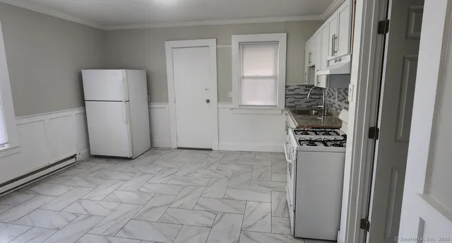 a view of a kitchen with a refrigerator
