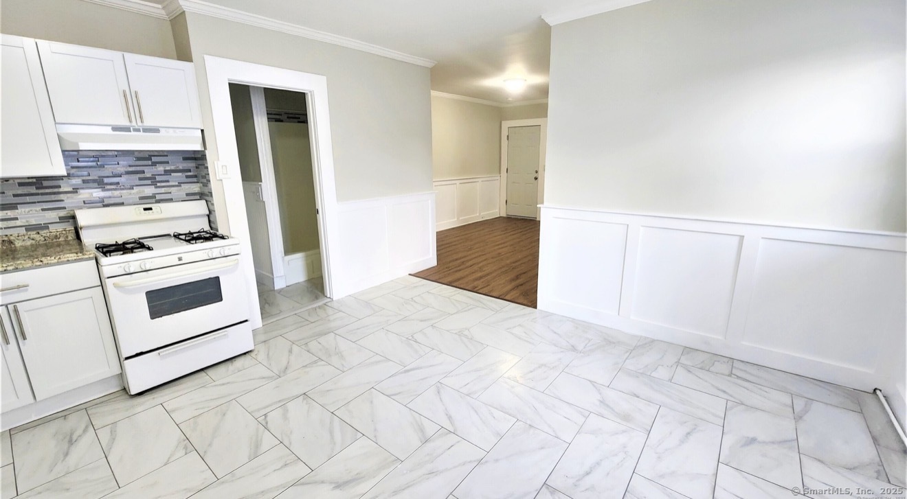 1514 Pembroke Street, Unit 2R Bridgeport, CT 06608 - Photo 3 of 7 a kitchen with white cabinets and white appliances