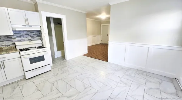 a kitchen with white cabinets and white appliances