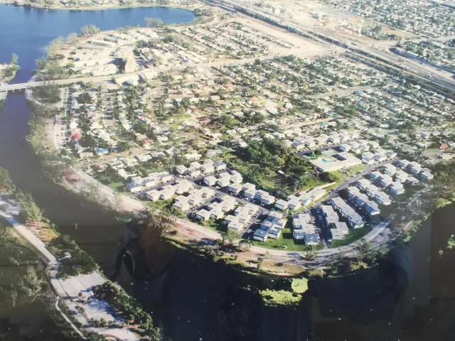 an empty room with wooden floor and cabinet