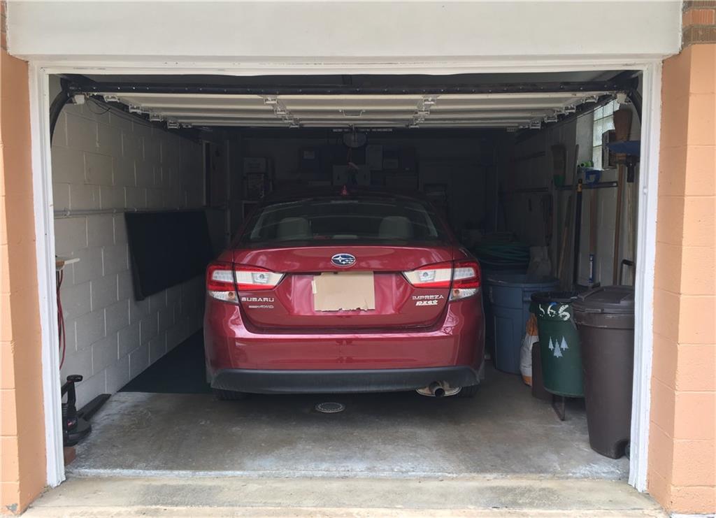 566 Filmore Road Pittsburgh, PA 15221 - Photo 24 of 25 Garage has a decent space considering there is a vehicle and trash cans in here together.