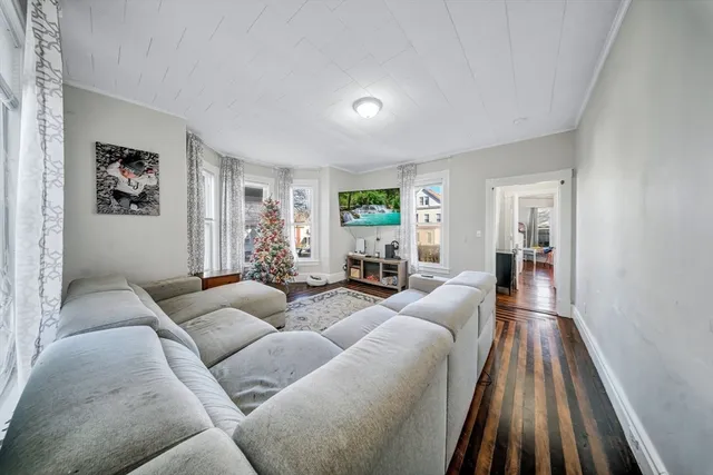 a spacious bedroom with a bed a table and a flat screen tv