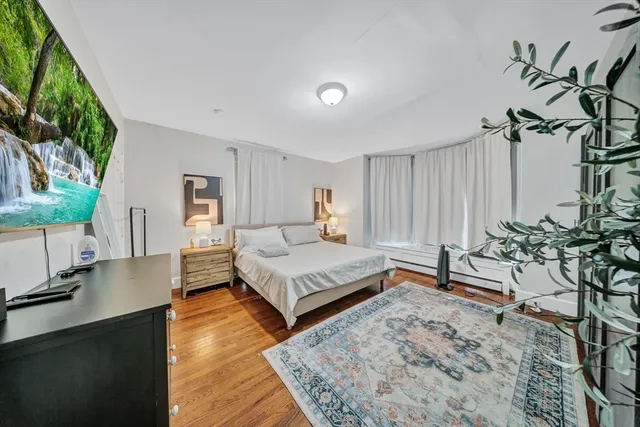 a bed room with a bed and a dresser