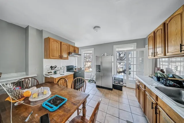 a kitchen with granite countertop stainless steel appliances a sink counter top space and cabinets