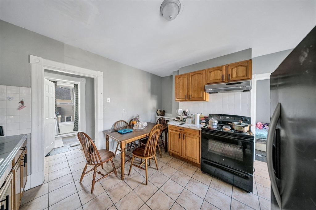 28 Richards Street Worcester, MA 01603 - Photo 26 of 42 a kitchen with granite countertop stainless steel appliances a sink counter top space and cabinets