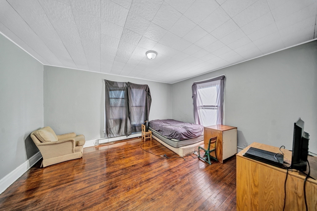 28 Richards Street Worcester, MA 01603 - Photo 27 of 42 a living room with furniture and a wooden floor