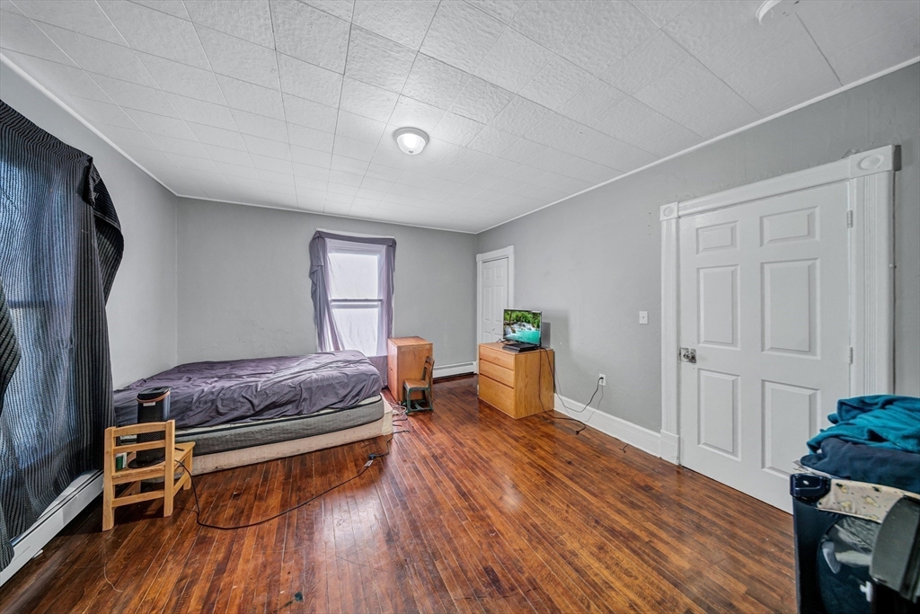 28 Richards Street Worcester, MA 01603 - Photo 28 of 42 a living room with furniture and a wooden floor