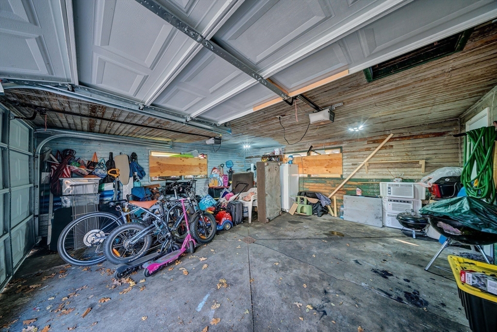 28 Richards Street Worcester, MA 01603 - Photo 41 of 42 a view of a garage with a bike and car