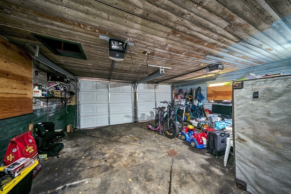 28 Richards Street Worcester, MA 01603 - Photo 42 of 42 a view of a garage with a bike and car