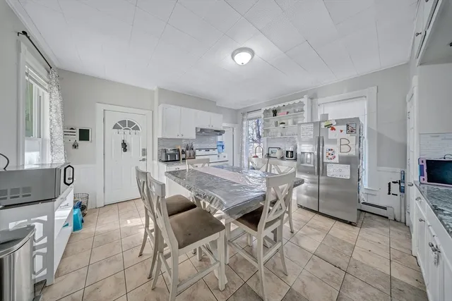 a kitchen with a table and chairs