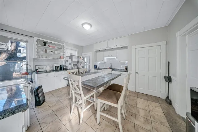 a view of a workspace with furniture and a flat screen tv
