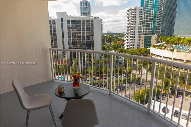 a view of a chairs and table in the balcony