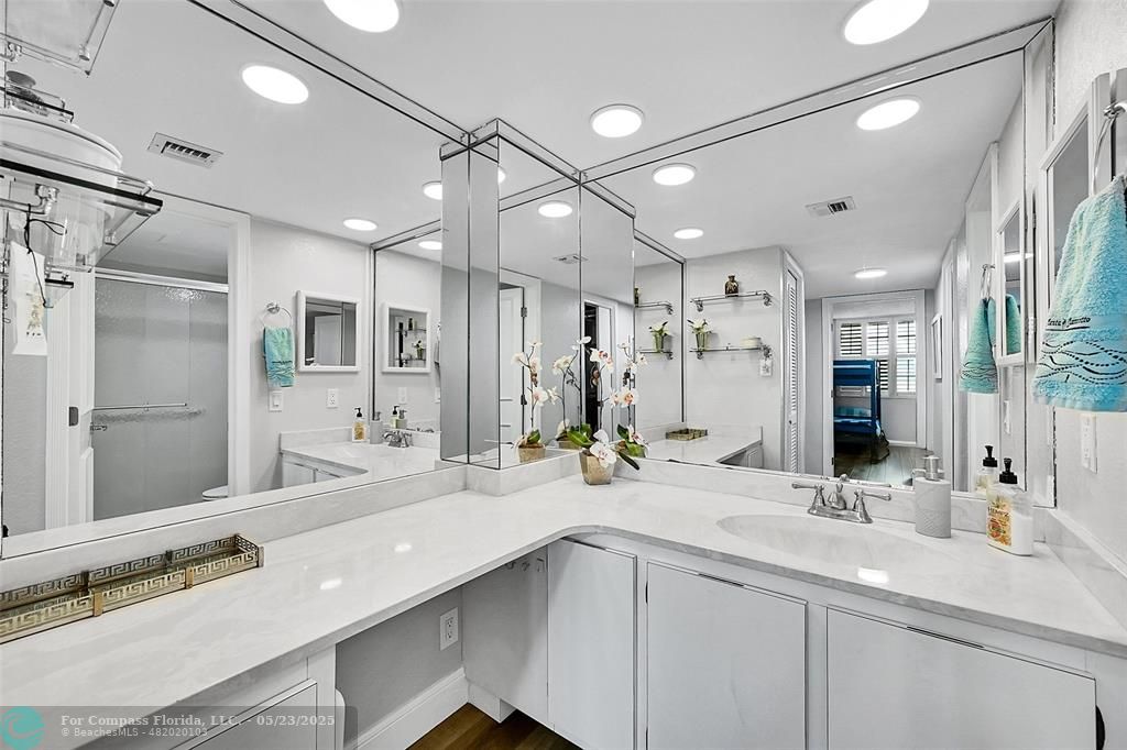 4020 West Palm Aire Drive, Unit 503 Pompano Beach, FL 33069 - Photo 21 of 53 a bathroom with double vanity sinks and a shower