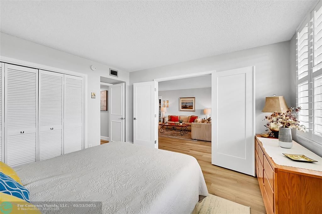 4020 West Palm Aire Drive, Unit 503 Pompano Beach, FL 33069 - Photo 25 of 53 a bedroom with a bed and a view of kitchen