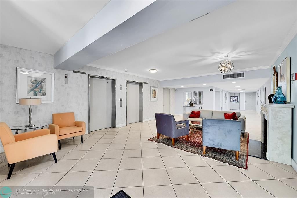 4020 West Palm Aire Drive, Unit 503 Pompano Beach, FL 33069 - Photo 36 of 53 a living room with furniture and a chandelier
