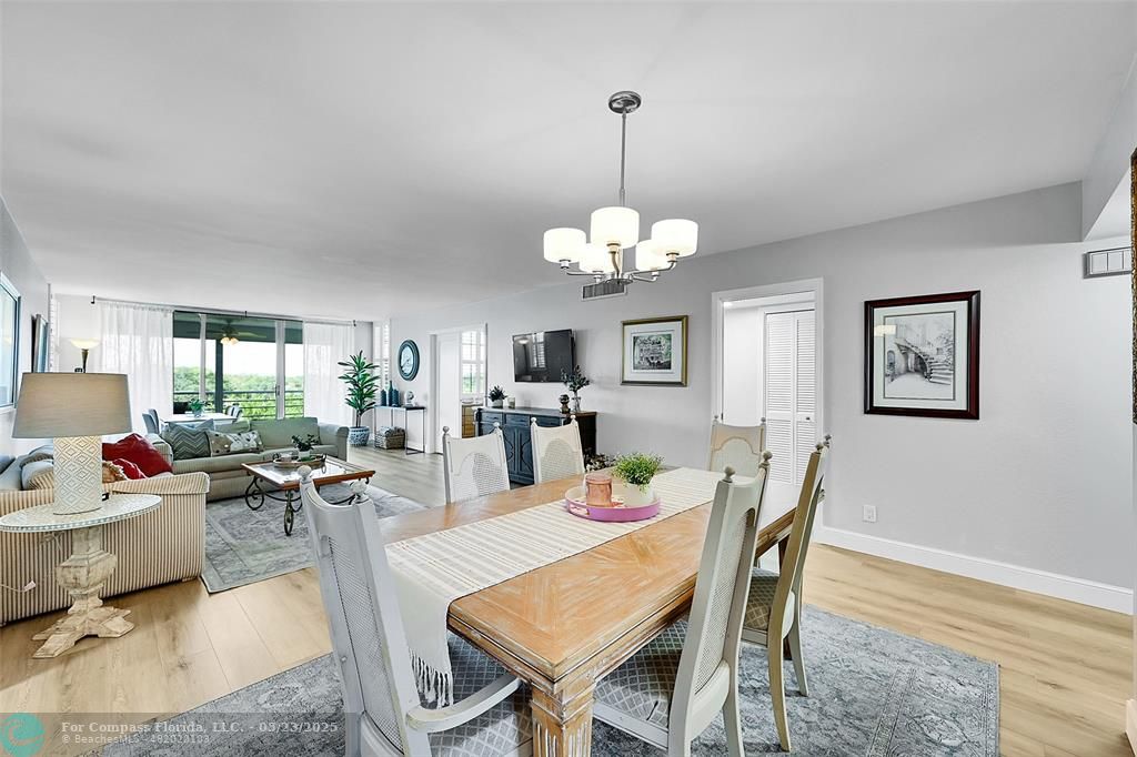 4020 West Palm Aire Drive, Unit 503 Pompano Beach, FL 33069 - Photo 4 of 53 a view of a dining room with furniture a chandelier and wooden floor