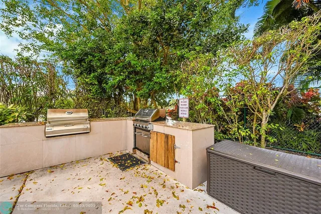 a view of a street with couches and a barbeque