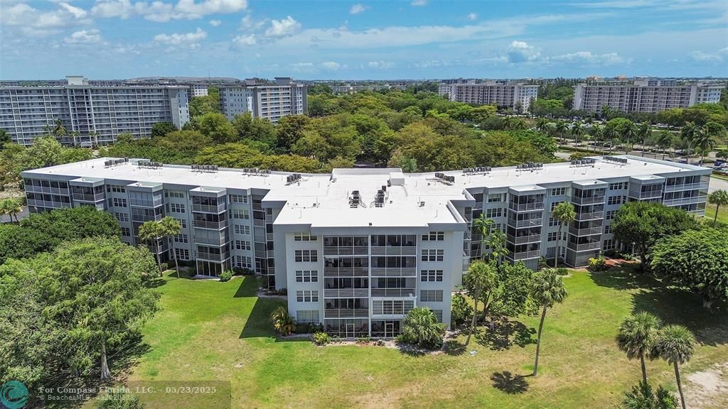 4020 West Palm Aire Drive, Unit 503 Pompano Beach, FL 33069 - Photo 47 of 53 a view of a chairs and table in backyard