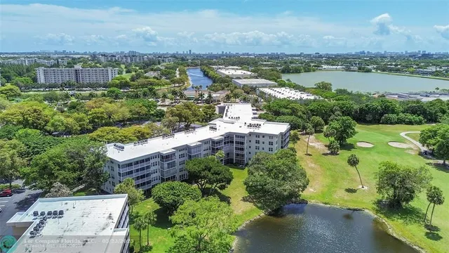 an aerial view of a house with a yard and lake view