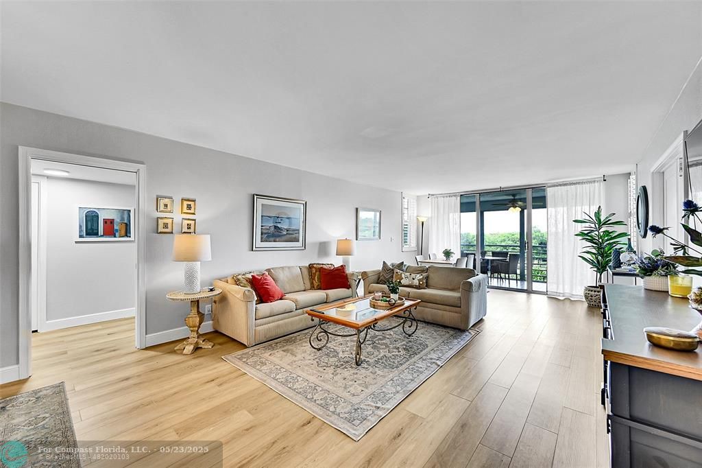 4020 West Palm Aire Drive, Unit 503 Pompano Beach, FL 33069 - Photo 6 of 53 a living room with furniture and a wooden floor