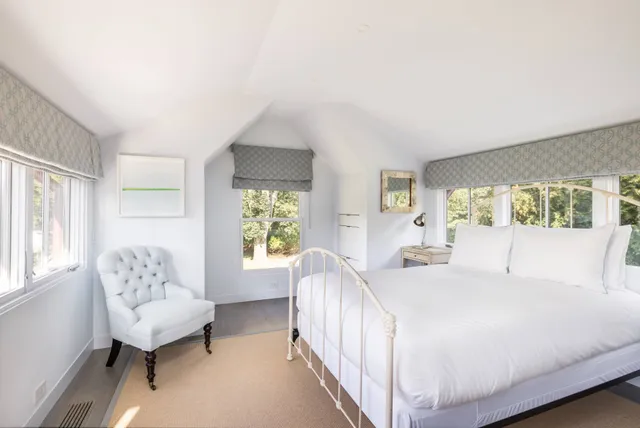 a bedroom with a large bed and a couch