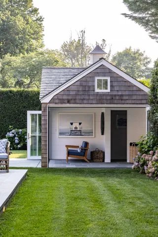 a front view of a house with a garden and plants