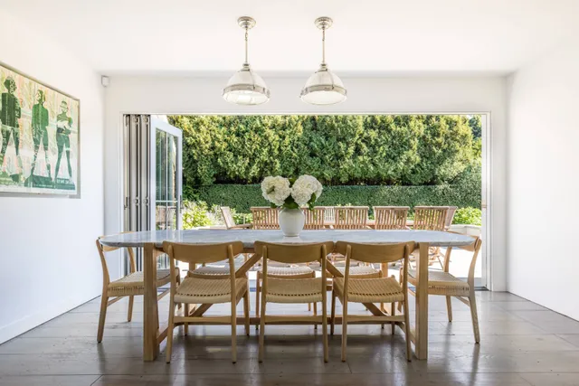 a dining room with furniture window and wooden floor