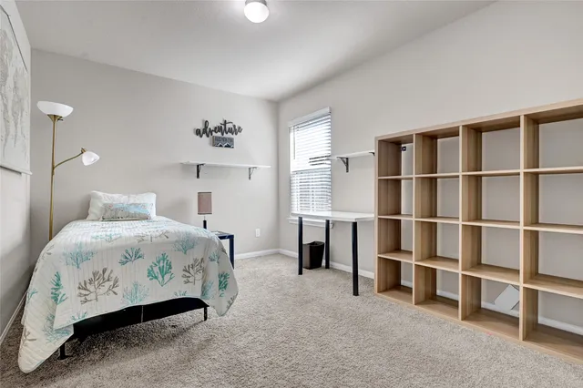 a bedroom with a bed and a window