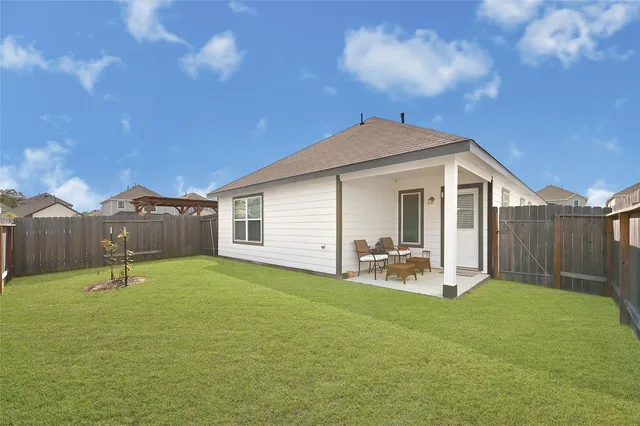 a backyard of a house with table and chairs
