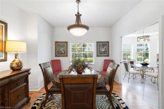 a view of a dining room with furniture wooden floor and chandelier