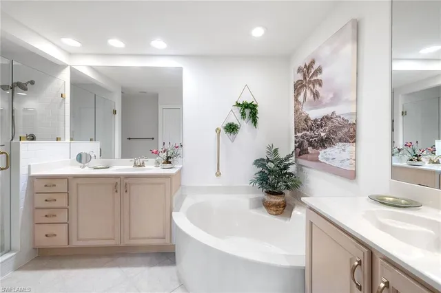 a bathroom with a bathtub sink and mirror