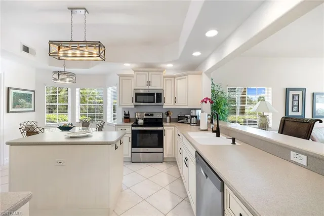 a kitchen with stainless steel appliances a sink stove and refrigerator