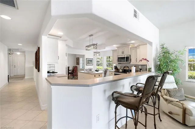 a large kitchen with a table and chairs