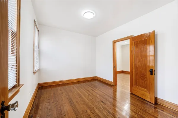 a view of a room with wooden floor and a window