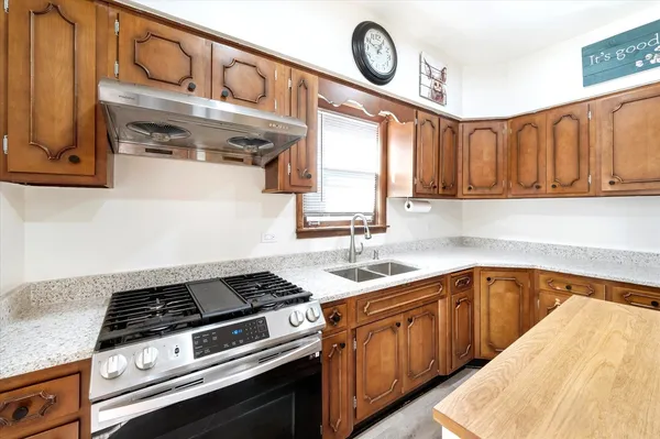 a kitchen with a stove and cabinets