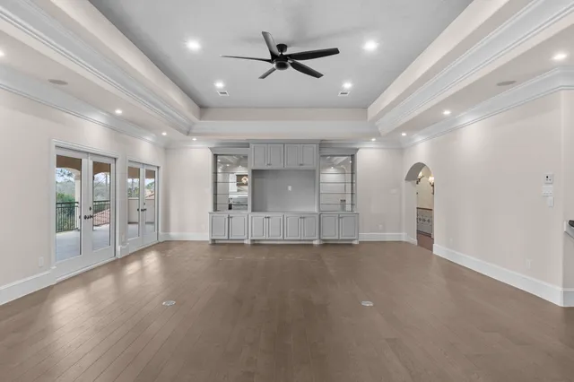 an empty room with fan and windows