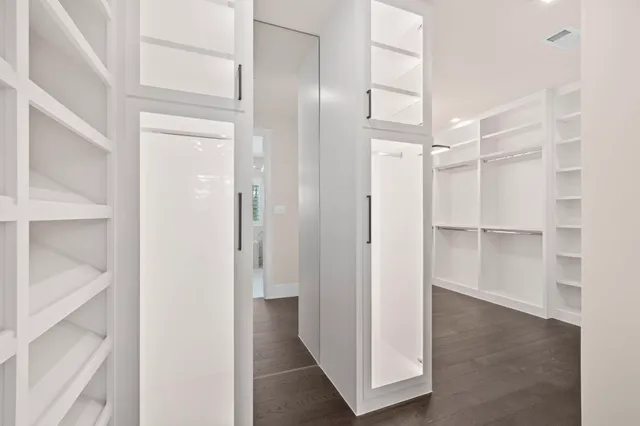 a view of walk in closet with empty racks