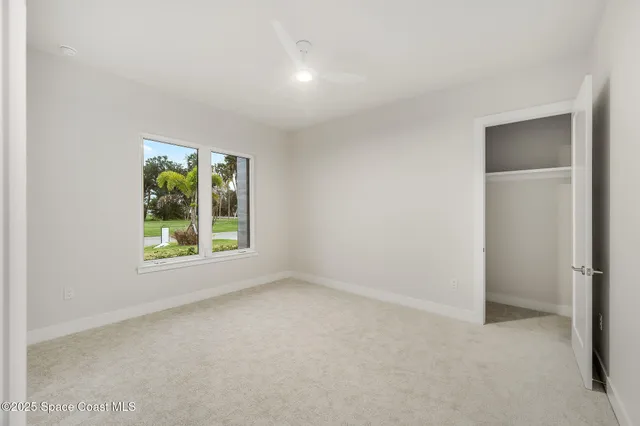 an aerial view of a house with swimming pool and lake view