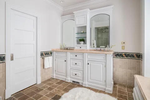 a spacious bathroom with a shower a sink and a mirror