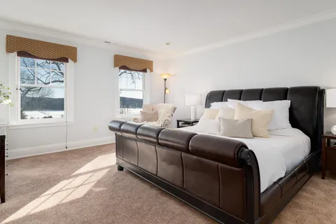 a bedroom with bed and window